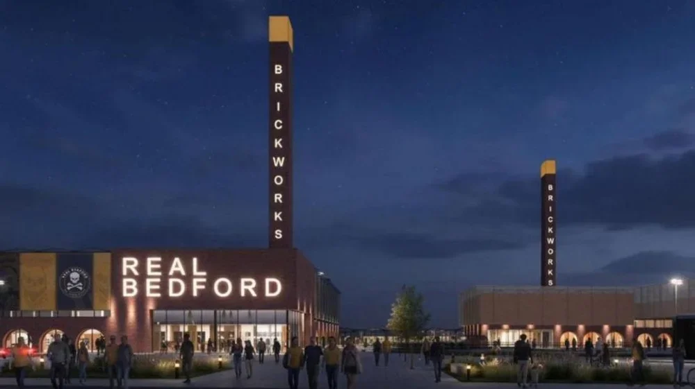 An artist's impression of a sporting campus including a football stadium belonging to Real Bedford. There are two tall chimney like structures with the word 