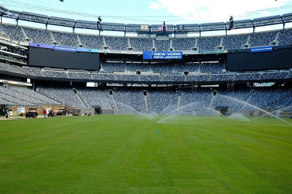Workers water the newly installed pitch at New York New Jersey Stadium (temporarily renamed from MetLife stadium) ahead of the 2026 FIFA World Cup, in East Rutherford, New Jersey on May 7, 2026